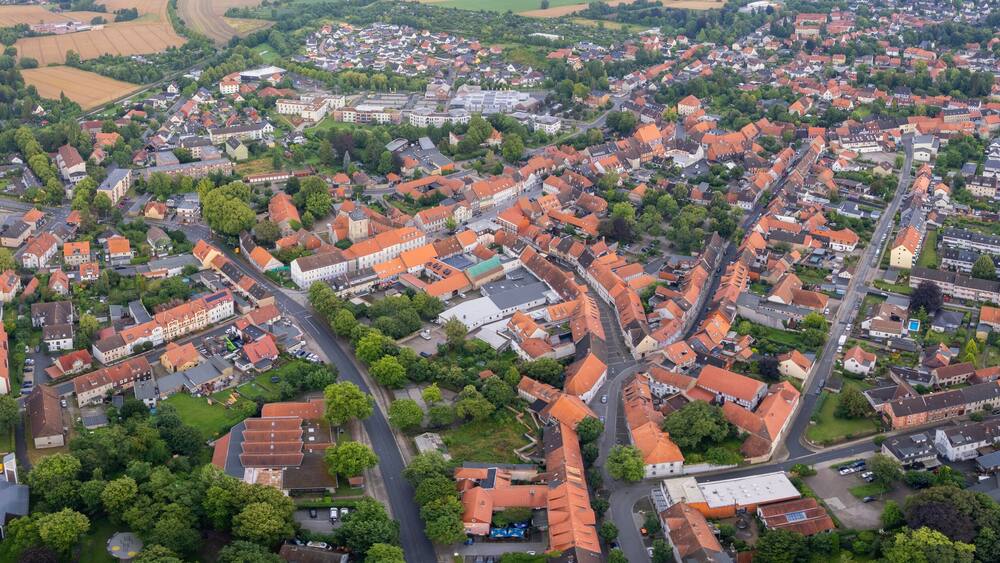 Aerial view around the old town in the city Königslutter am Elm, on an cloudy spring noon