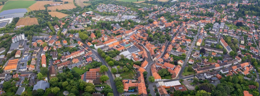 Aerial view around the old town in the city Königslutter am Elm, on an cloudy spring noon