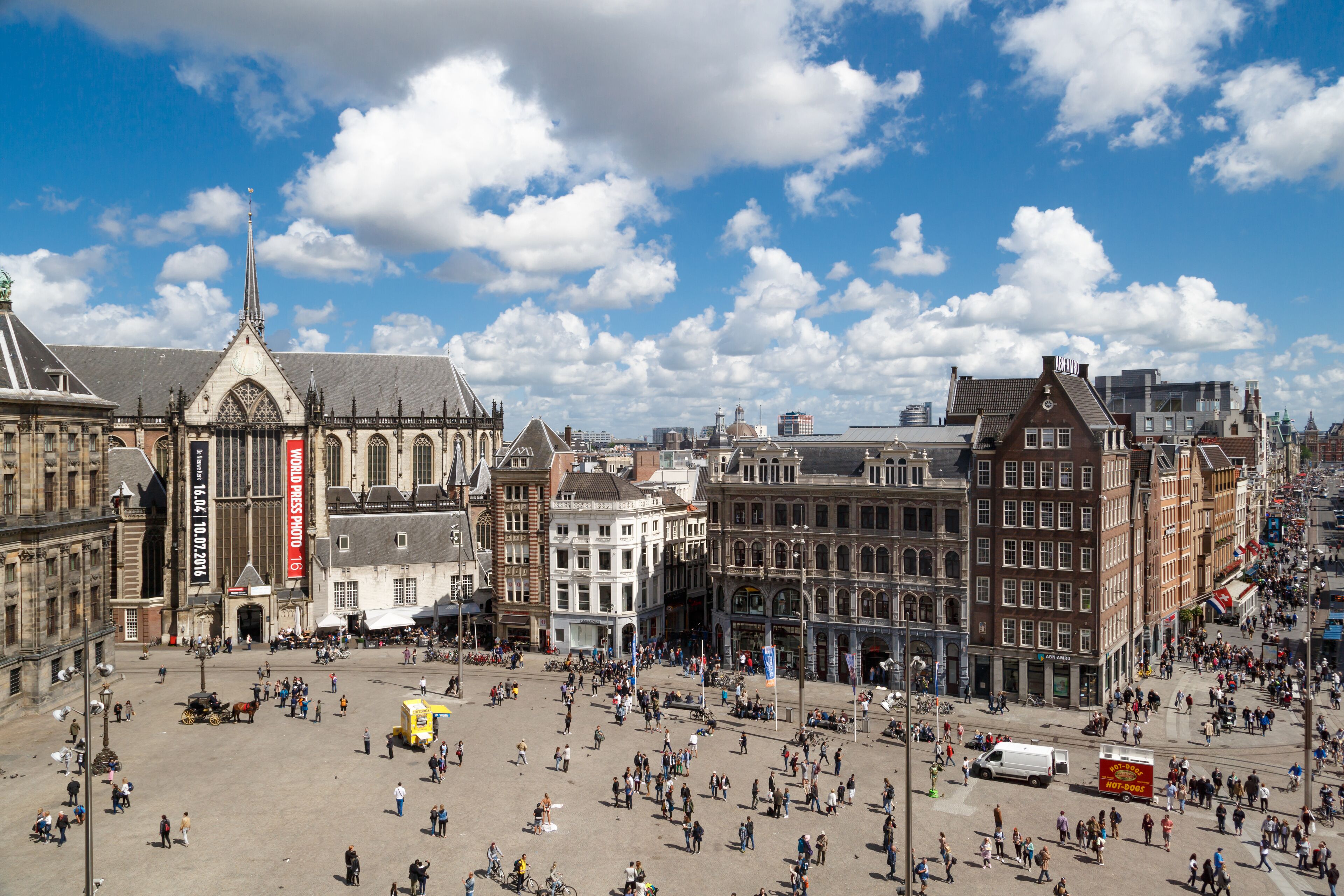 AMSTERDAM, NETHERLANDS - JULY 02, 2016 - Wide view of Dam Square in Amsterdam on cloudy sky background. Dam Square is one of the most popular meeting points in Amsterdam.