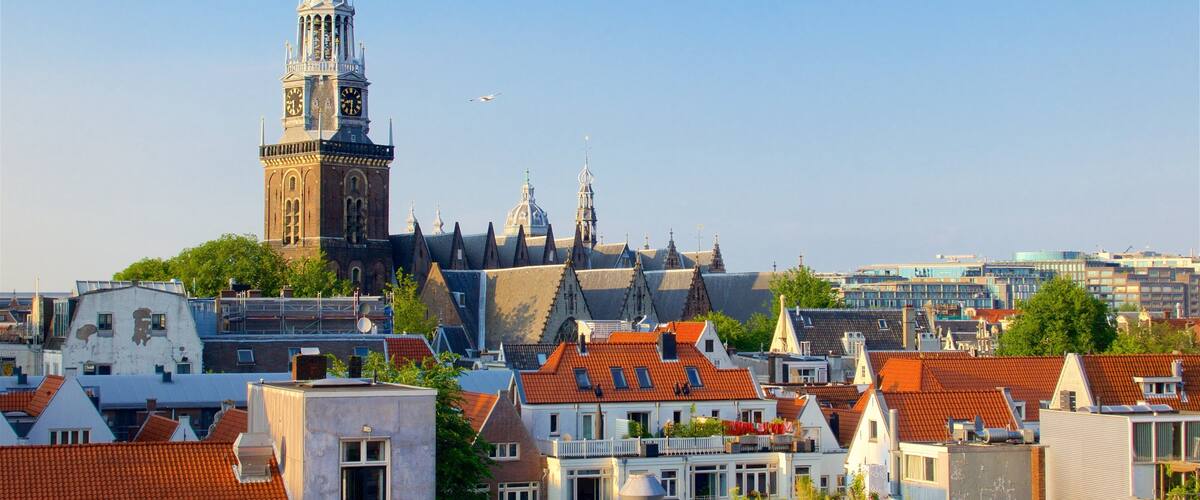 Ámsterdam mostrando elementos del patrimonio, una puesta de sol y una ciudad