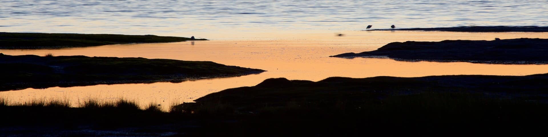 Anchorage featuring a sunset, mountains and general coastal views
