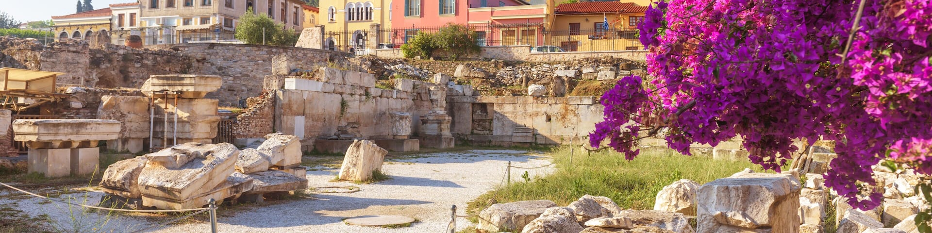 Sunny panoramic view of the Library of Hadrian, Athens, Greece. It is one of the main landmarks of Athens. Beautiful scenery of Athens with ancient Greek ruins. Historical architecture of Athens.