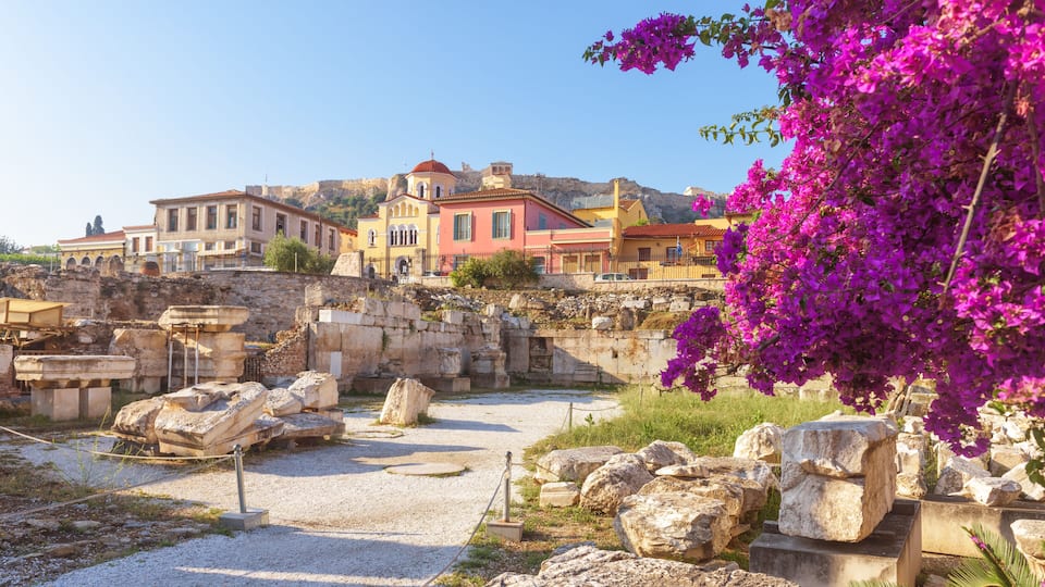 Sunny panoramic view of the Library of Hadrian, Athens, Greece. It is one of the main landmarks of Athens. Beautiful scenery of Athens with ancient Greek ruins. Historical architecture of Athens.