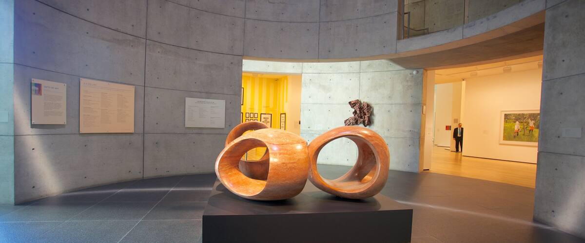 Contemporary art installation featuring wooden sculptures in Baltimore's cultural center with nearby exhibits