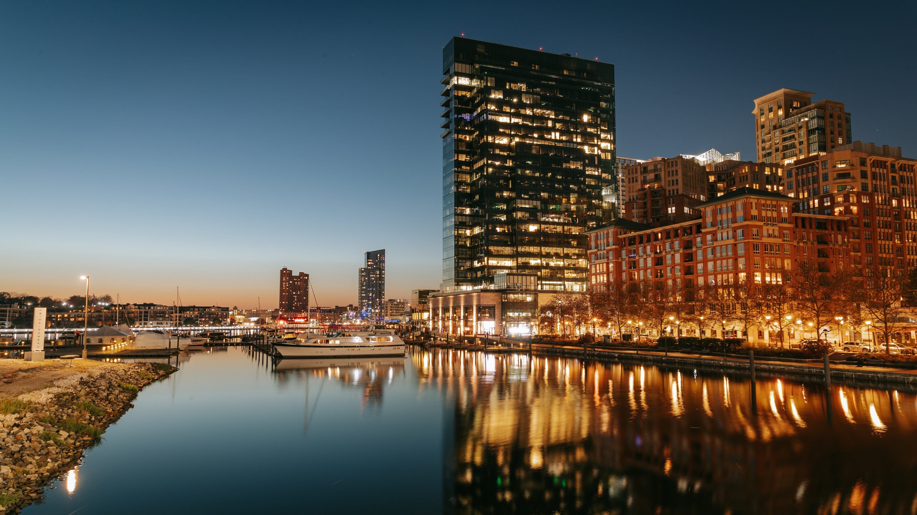Baltimore showing night scenes, a bay or harbor and a city