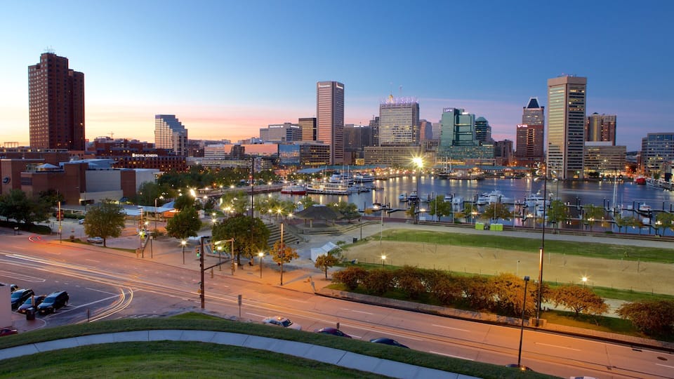 A city skyline with high-rise buildings, a marina with boats, and a river.
