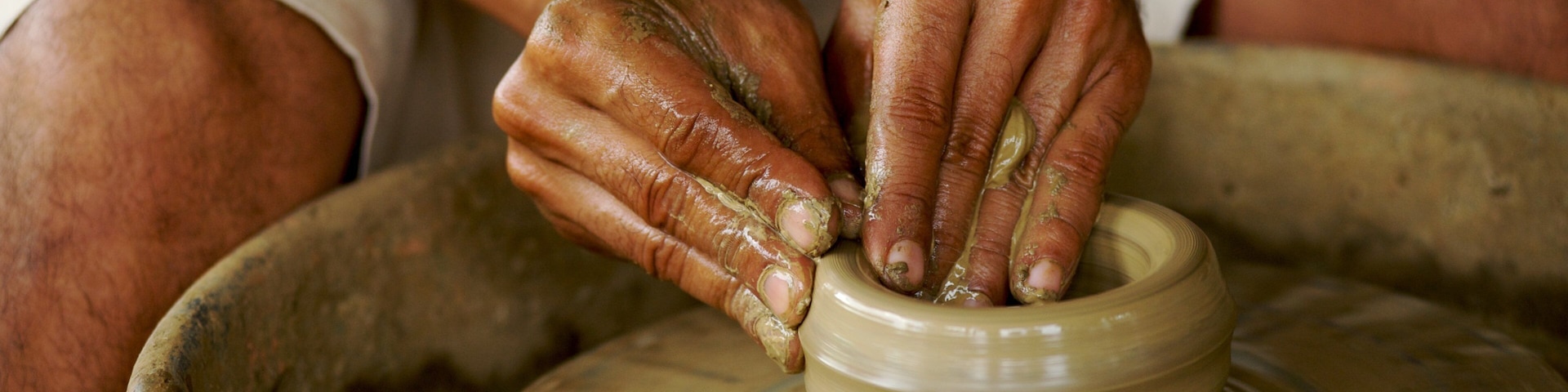 Crafting traditional pottery in Bangkok, Thailand with skilled hands shaping clay on a spinning wheel