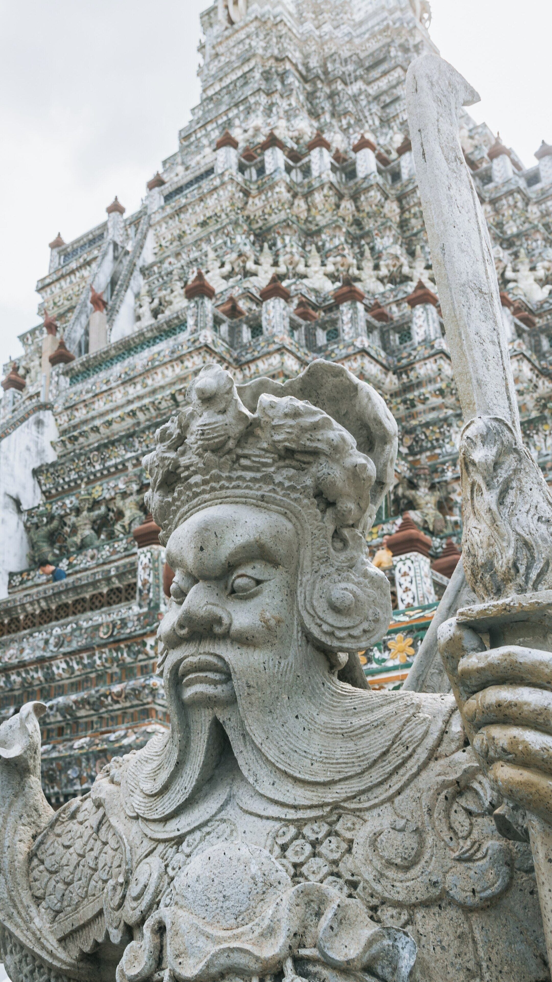 Exploring Wat Arun in Bangkok Yai, Thailand featuring intricate architecture and detailed sculptures