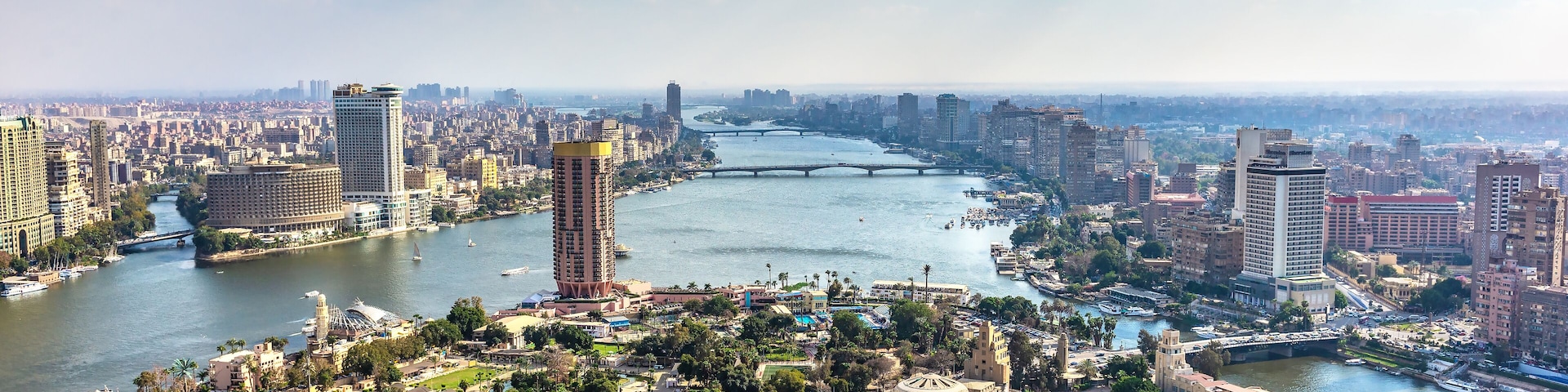 A cityscape with a river, bridges, and a large mosque.