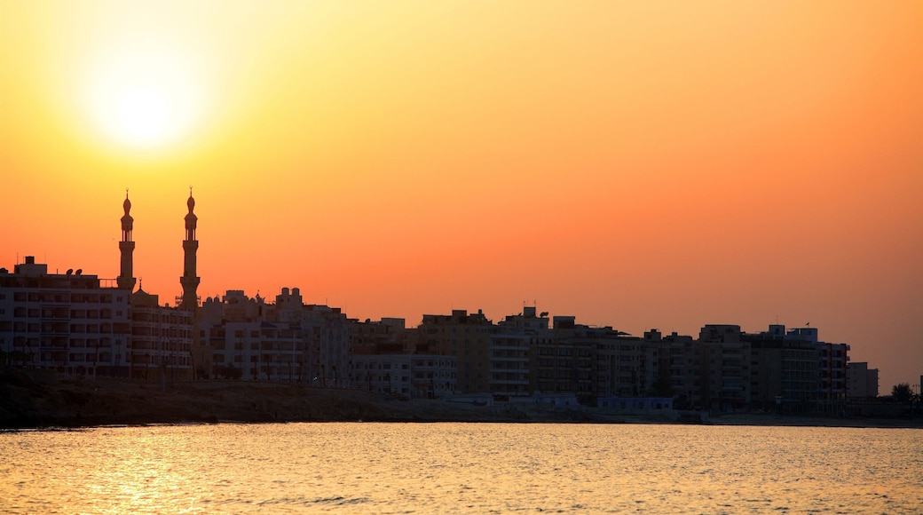 Cairo showing a coastal town, a sunset and general coastal views