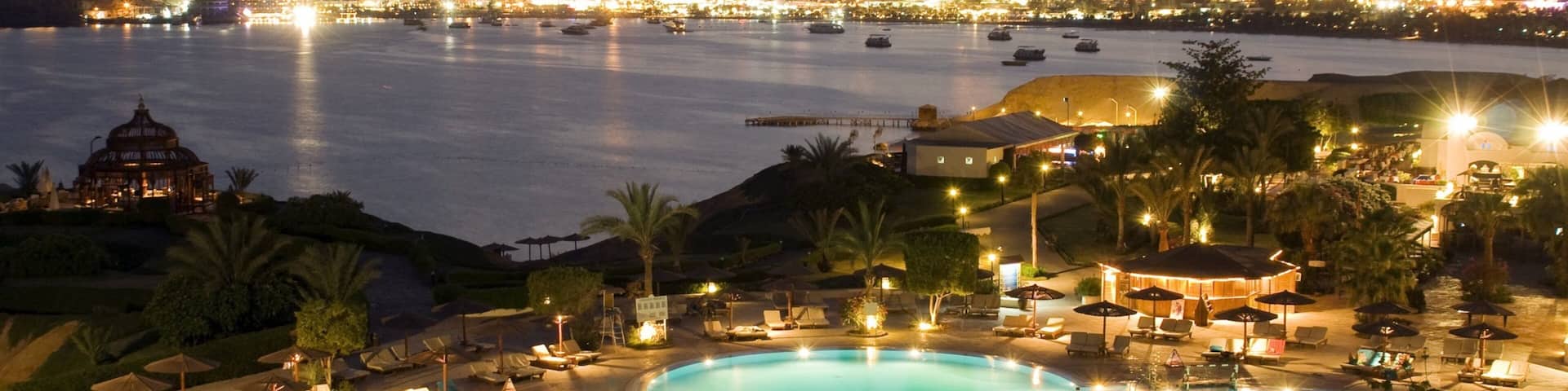 Cairo showing a coastal town, a pool and modern architecture