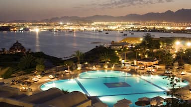 Cairo showing a coastal town, a pool and modern architecture