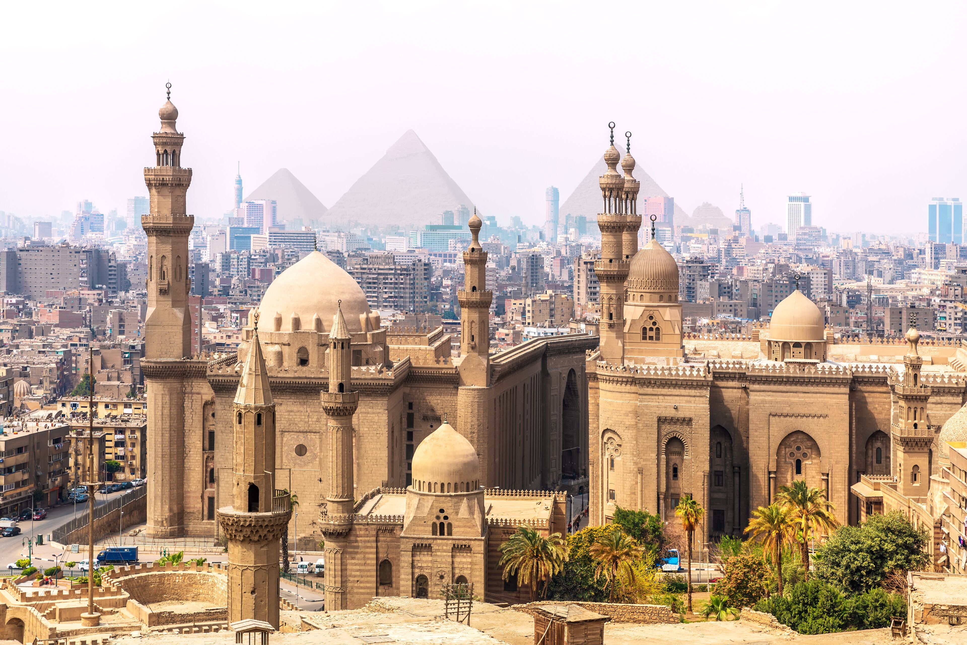 The Mosque-Madrassa of Sultan Hassan and the Pyramids in the background, Cairo, Egypt.