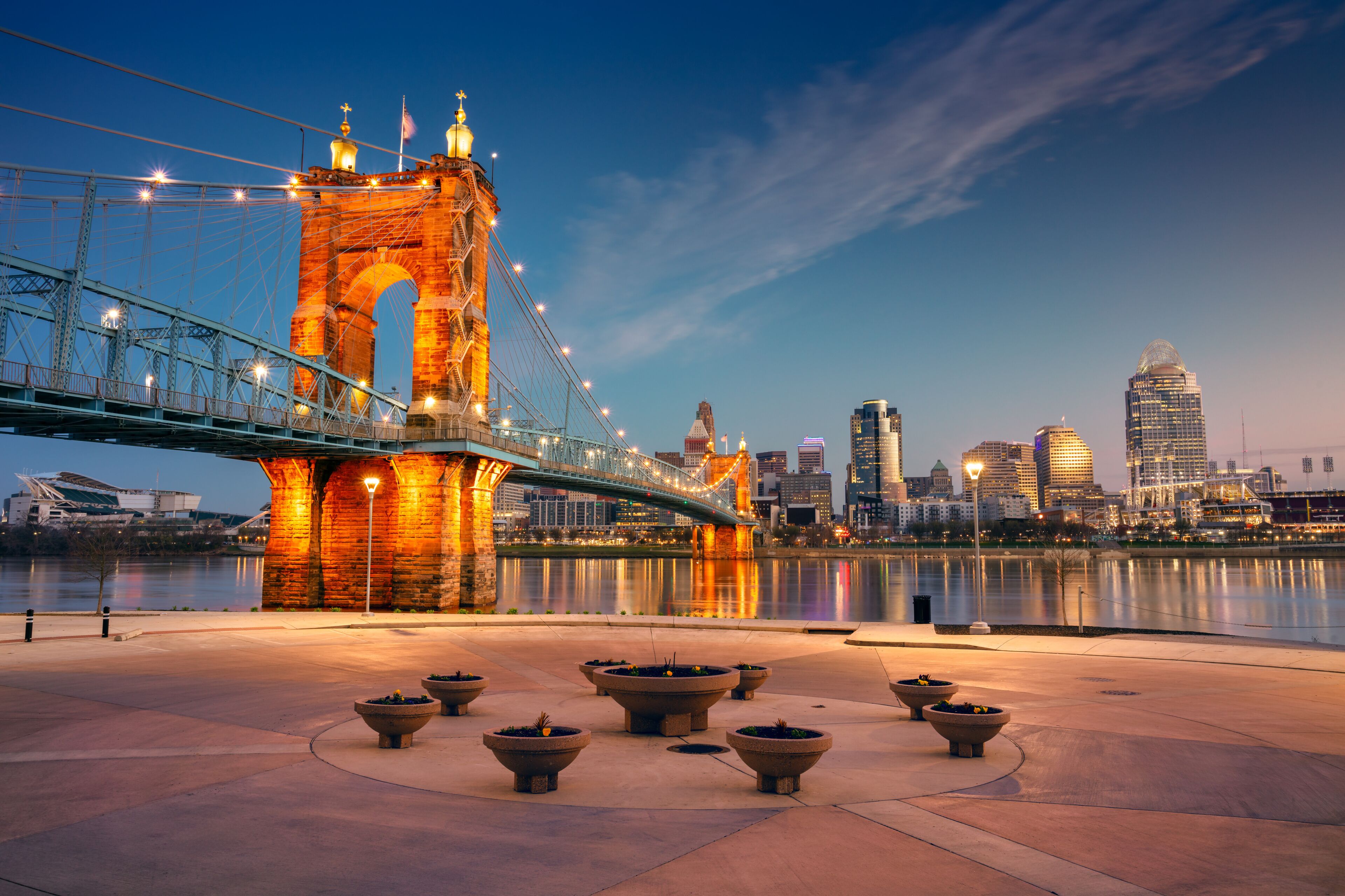 Cincinnati, Ohio, USA. Cityscape image of Cincinnati, Ohio, USA downtown skyline with the John A. Roebling Suspension Bridge and reflection of the city in the Ohio River at spring sunrise.