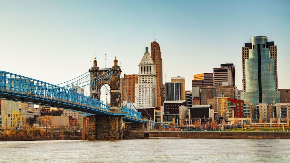 A city skyline with a prominent bridge and various buildings.
