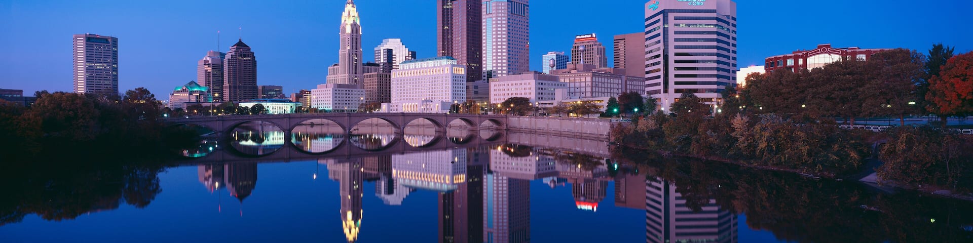 Scioto River and Columbus Ohio skyline, the capital city, at dusk with lights on