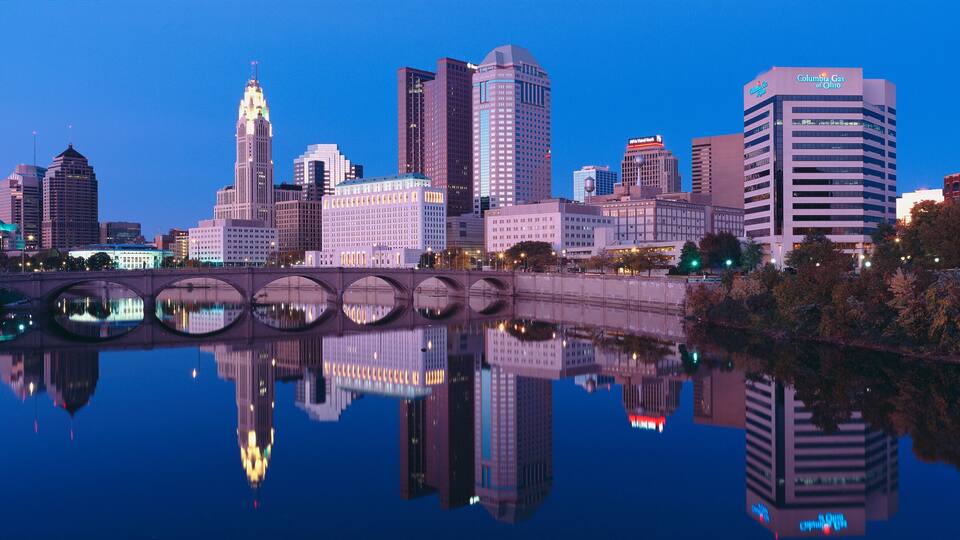Scioto River and Columbus Ohio skyline, the capital city, at dusk with lights on