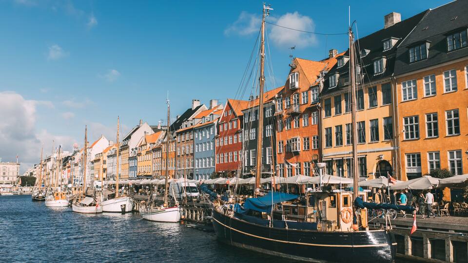 A harbor with colorful buildings and boats docked along the waterfront.