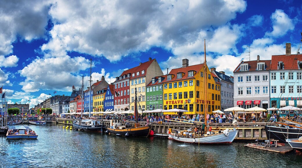 A colorful waterfront with traditional buildings and boats docked along the quay.