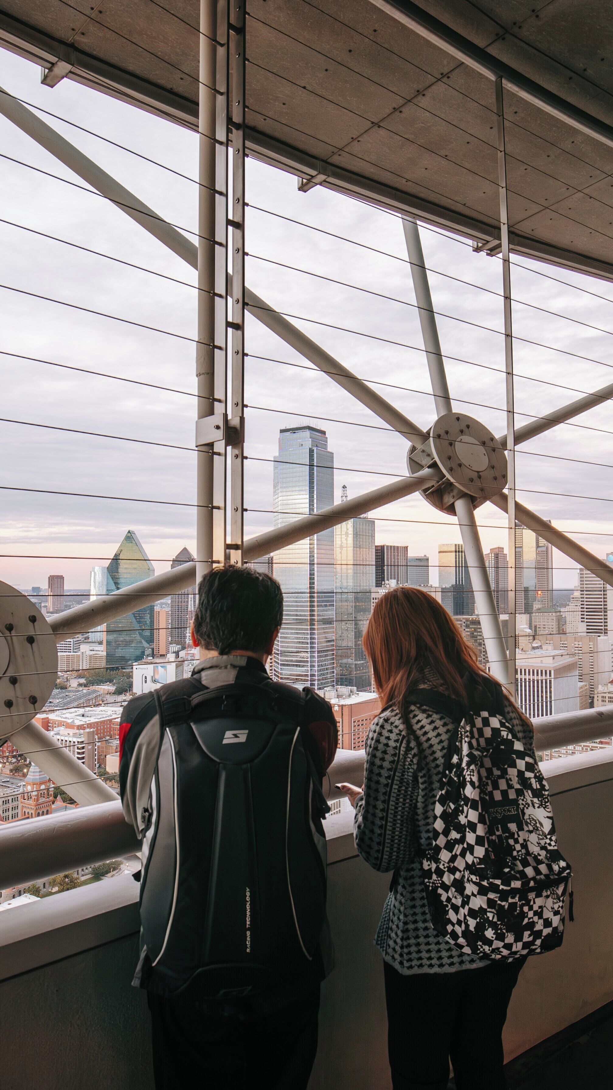 Visitors enjoy a panoramic view of Downtown Dallas from Reunion Tower in Texas during a cloudy afternoon
