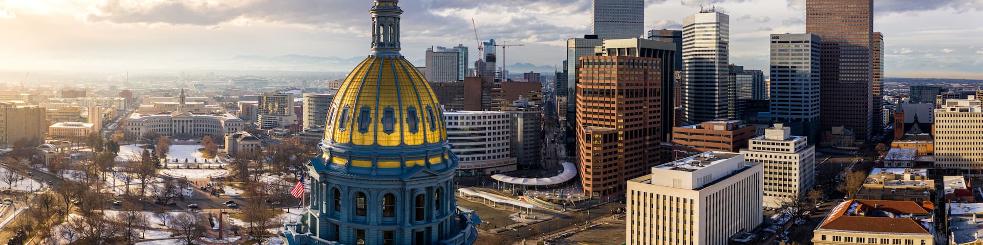 Colorado State Capitol Building & the City of Denver Colorado at Sunset. Rocky Mountains on the Horizon