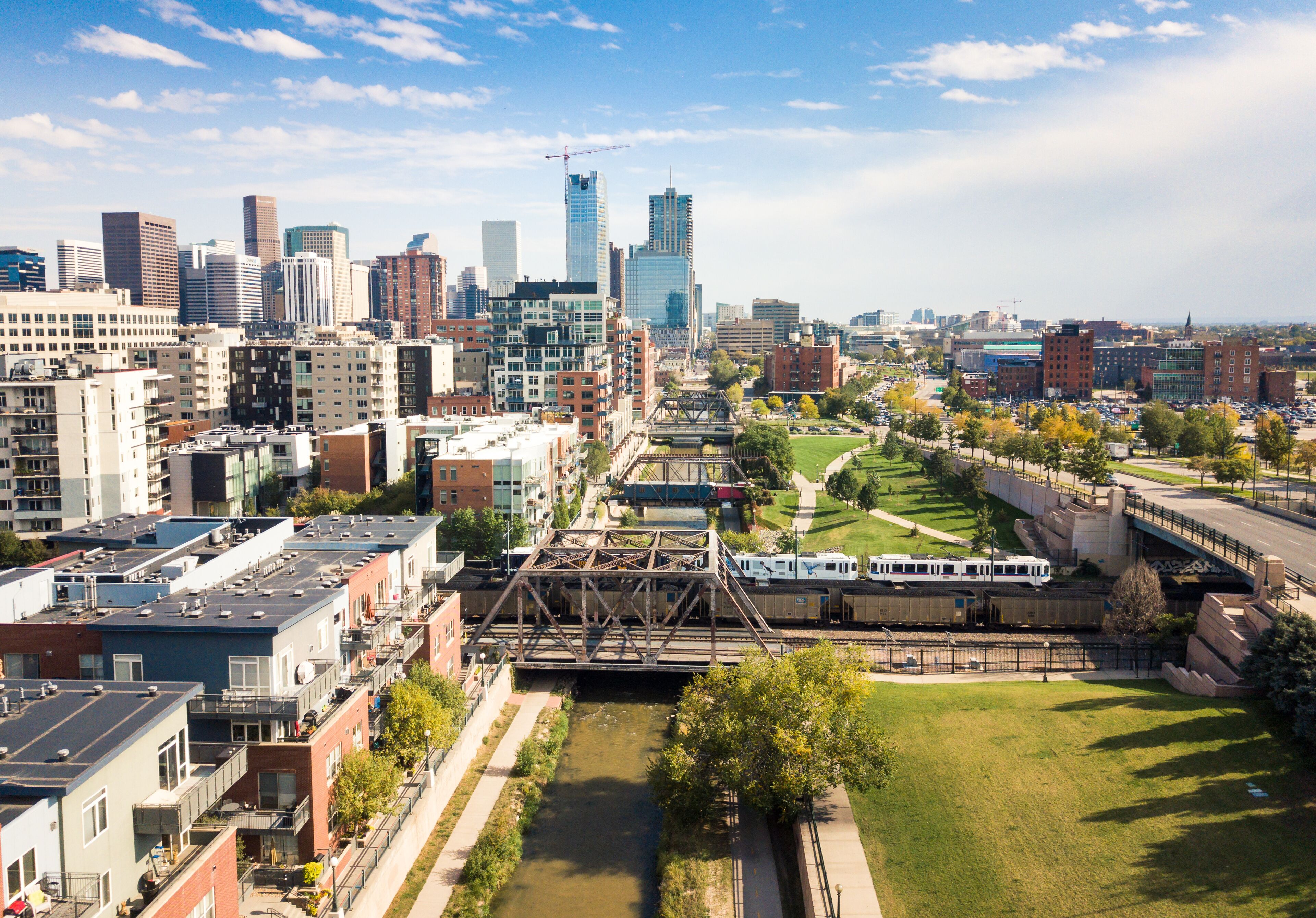 Denver cityscape aerial view with bridges over cherry creek river and skyscrapers