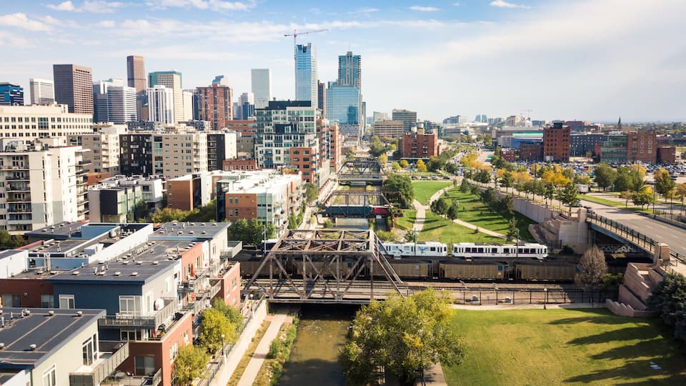 Denver cityscape aerial view with bridges over cherry creek river and skyscrapers