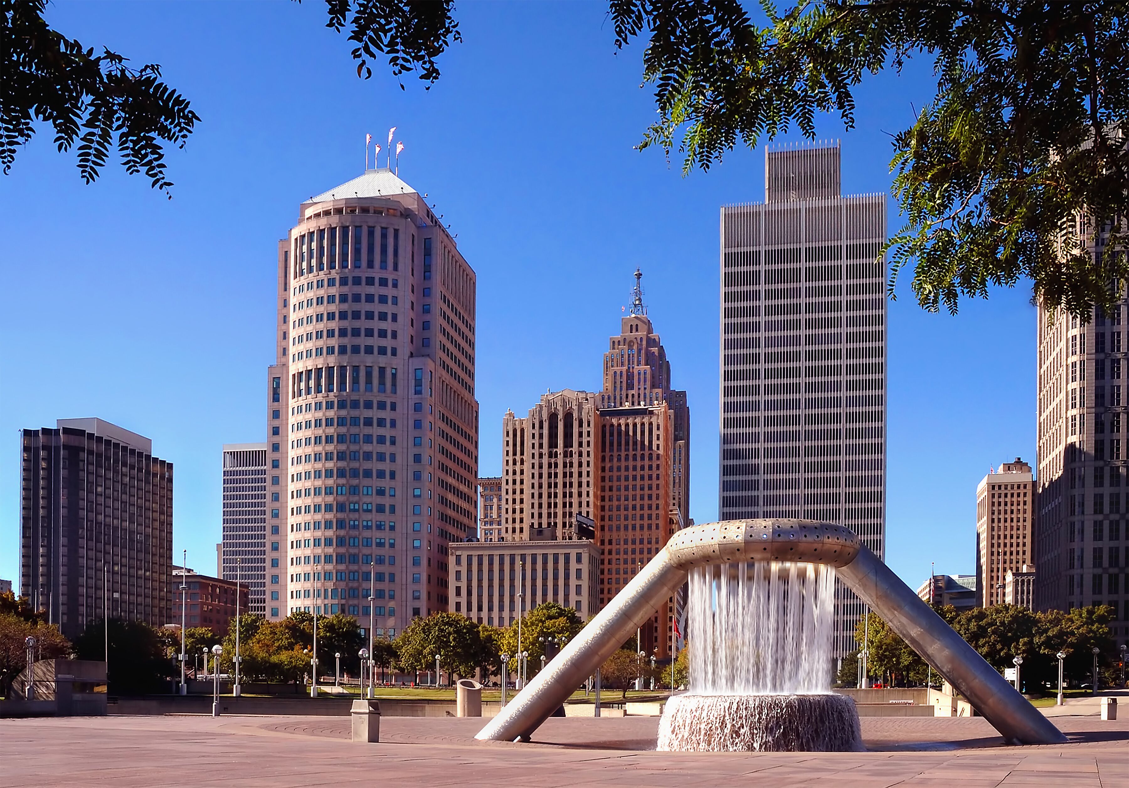 A cityscape with a prominent water feature in the foreground.