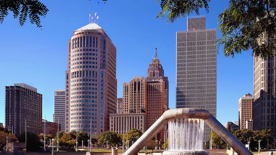 A cityscape with a prominent water feature in the foreground.
