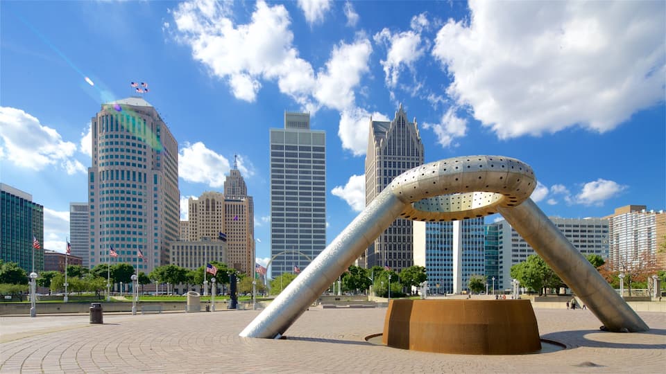 A cityscape with modern skyscrapers and a large metallic sculpture in the foreground.