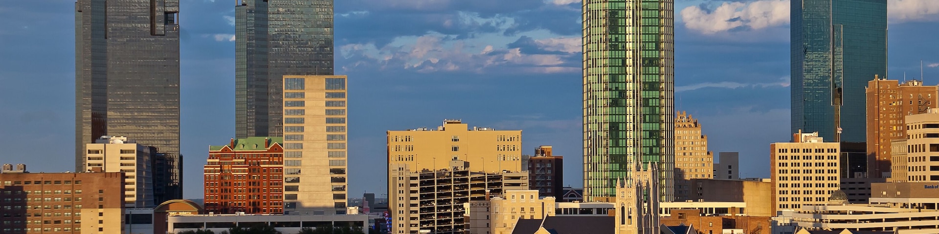 A city skyline with modern skyscrapers and residential houses.