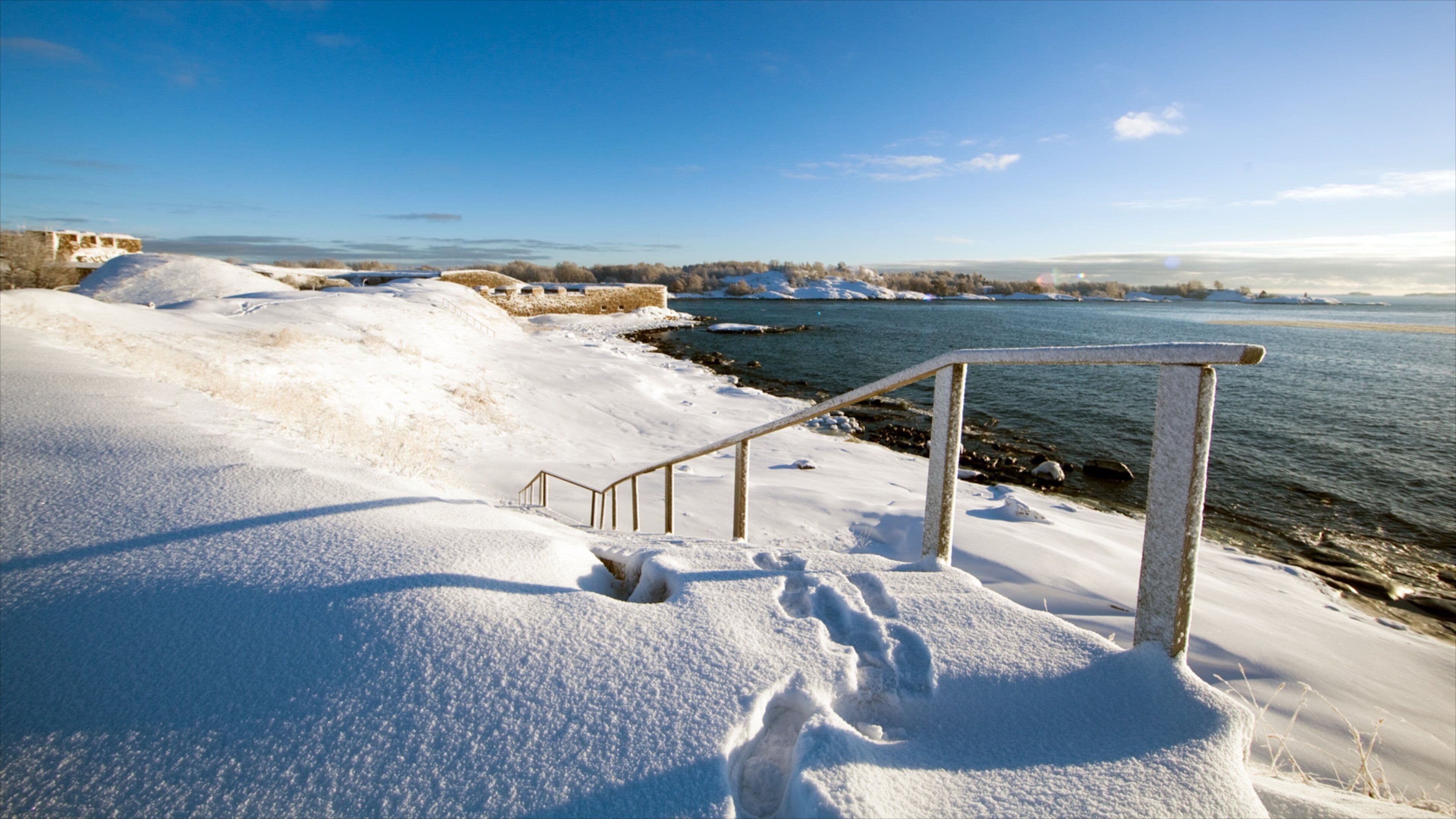 Helsinki showing a sandy beach, landscape views and snow