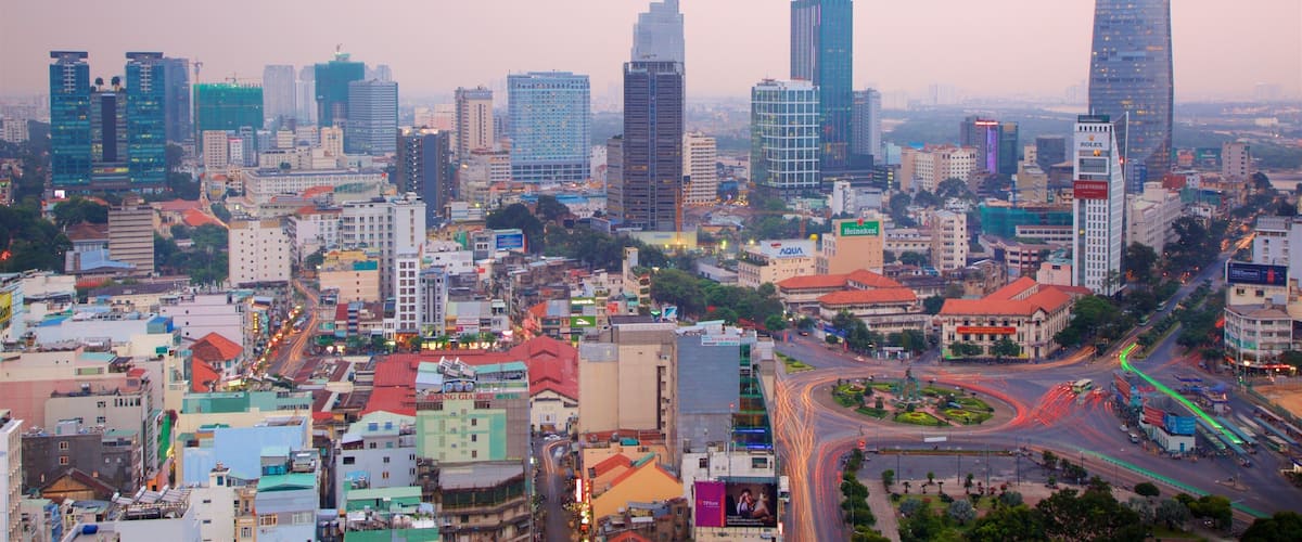 A cityscape with modern skyscrapers, a busy intersection, and a mix of commercial and residential buildings.