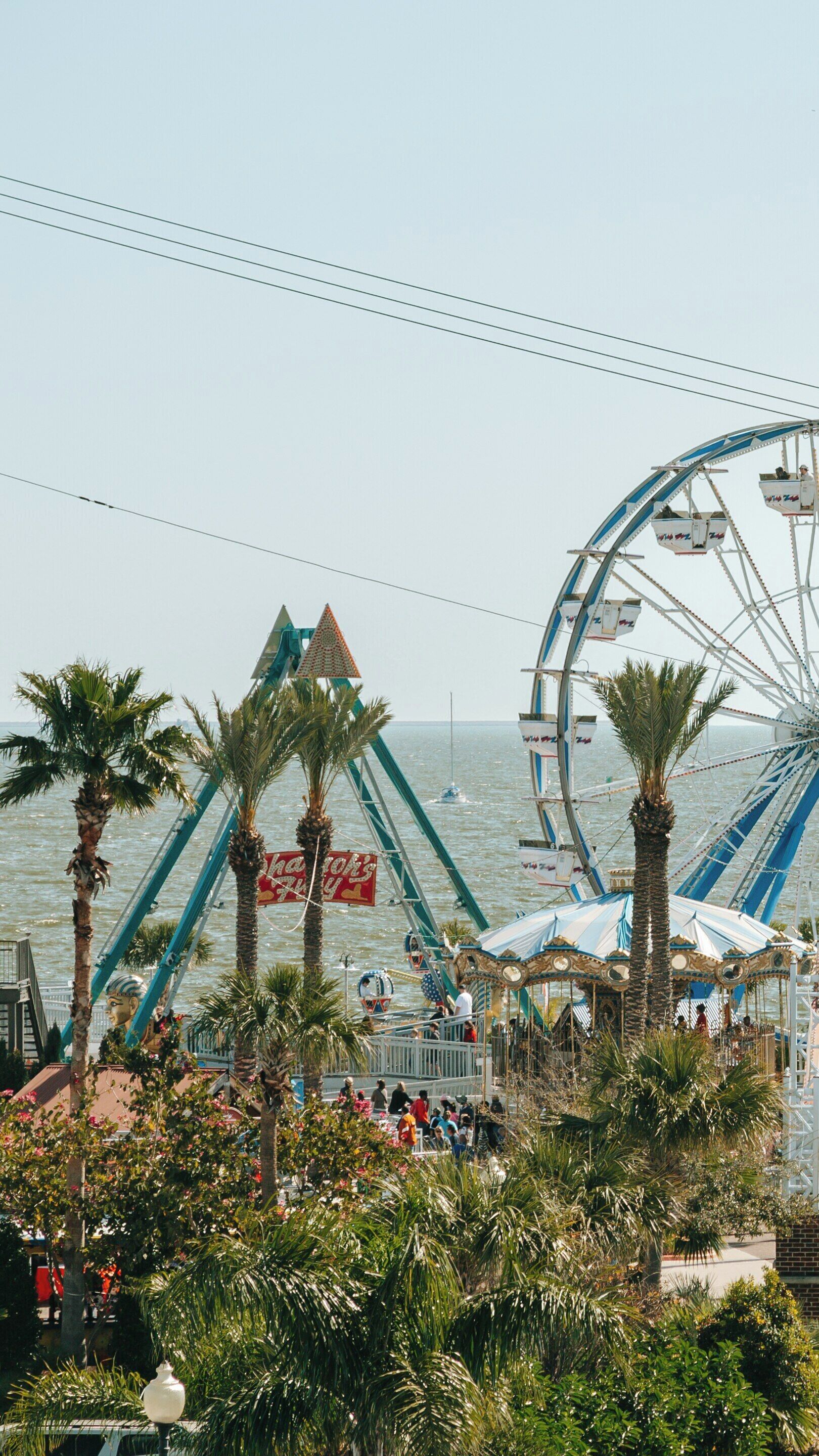 Kemah Boardwalk offers fun and excitement near the serene waters of Clear Lake in Kemah, Texas with vibrant attractions and palm trees swaying in the breeze