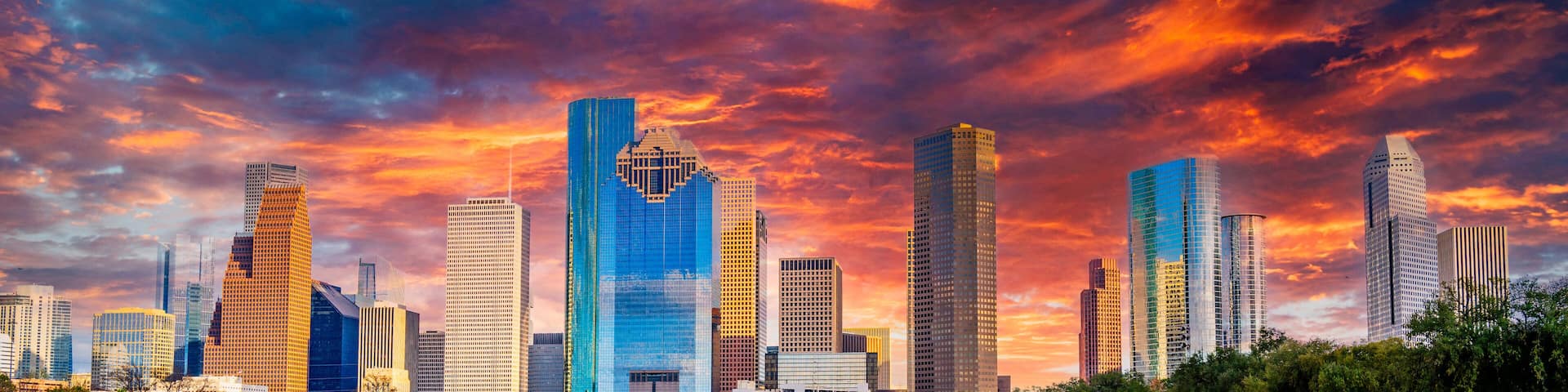Houston Texas downtown buildings and city skyline, panoramic metropolis landscape with dramatic clouds over the public park at sunset