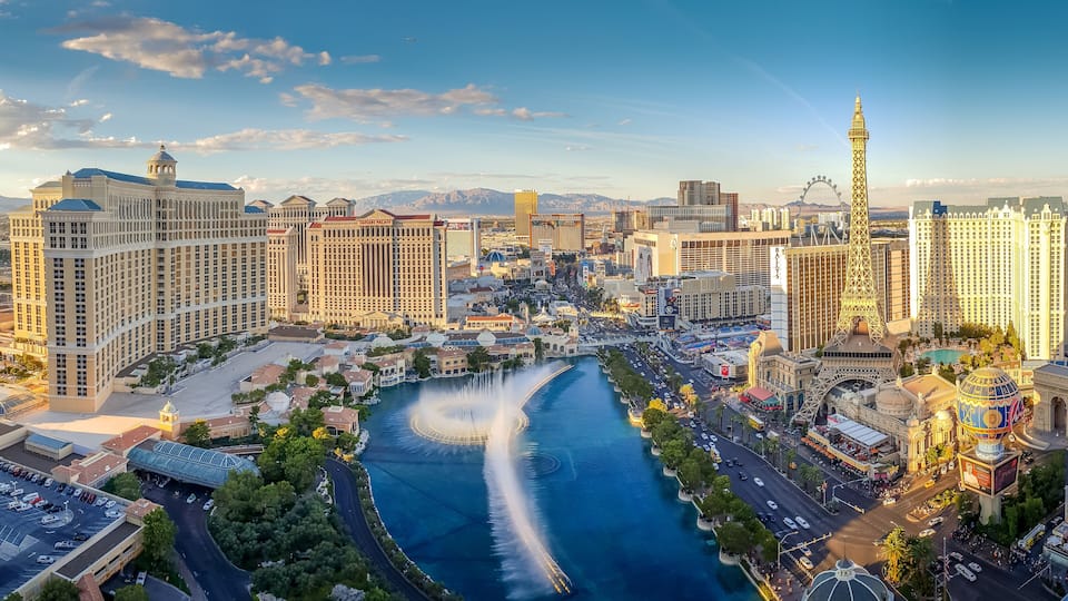 A cityscape with a river, prominent buildings, and a tower.