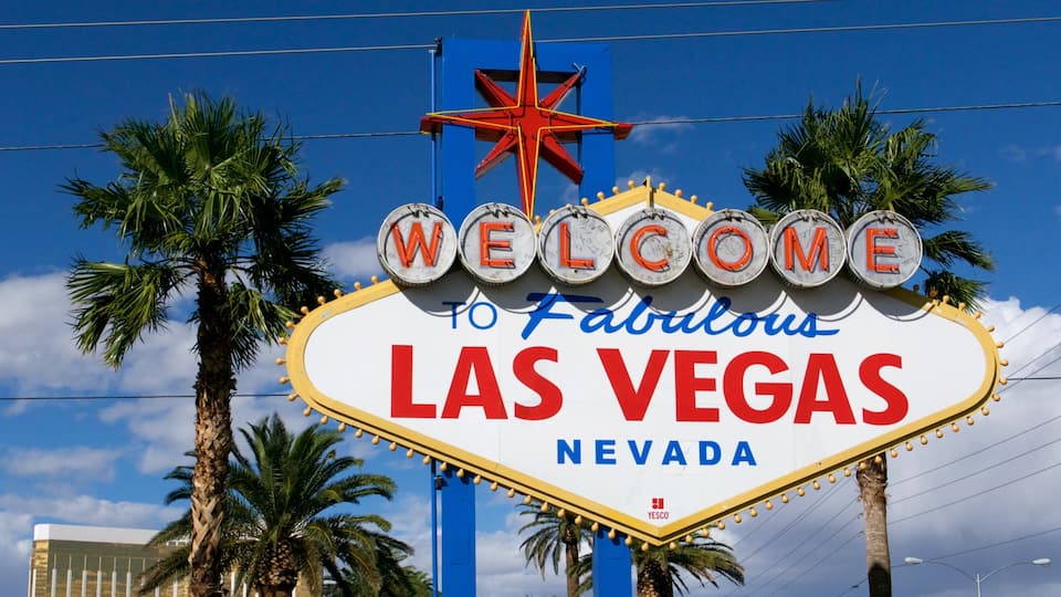 A neon sign with 'WELCOME TO Fabulous LAS VEGAS' and a star above it.