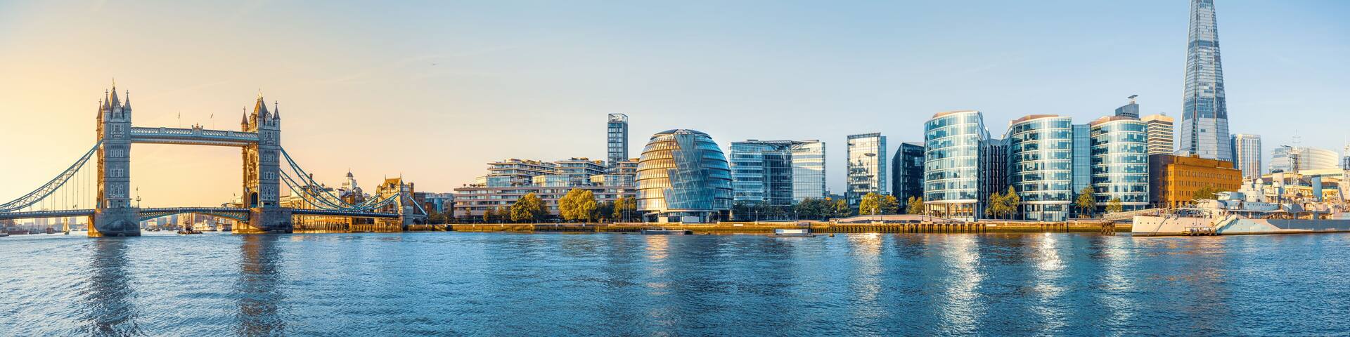 The Tower Bridge and modern buildings along the River Thames in London.
