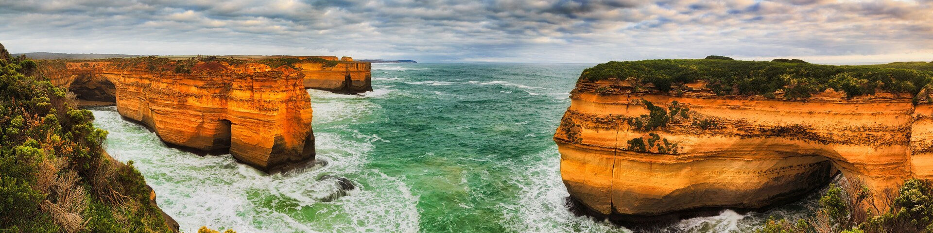 A coastal landscape with prominent cliffs and a turbulent sea.