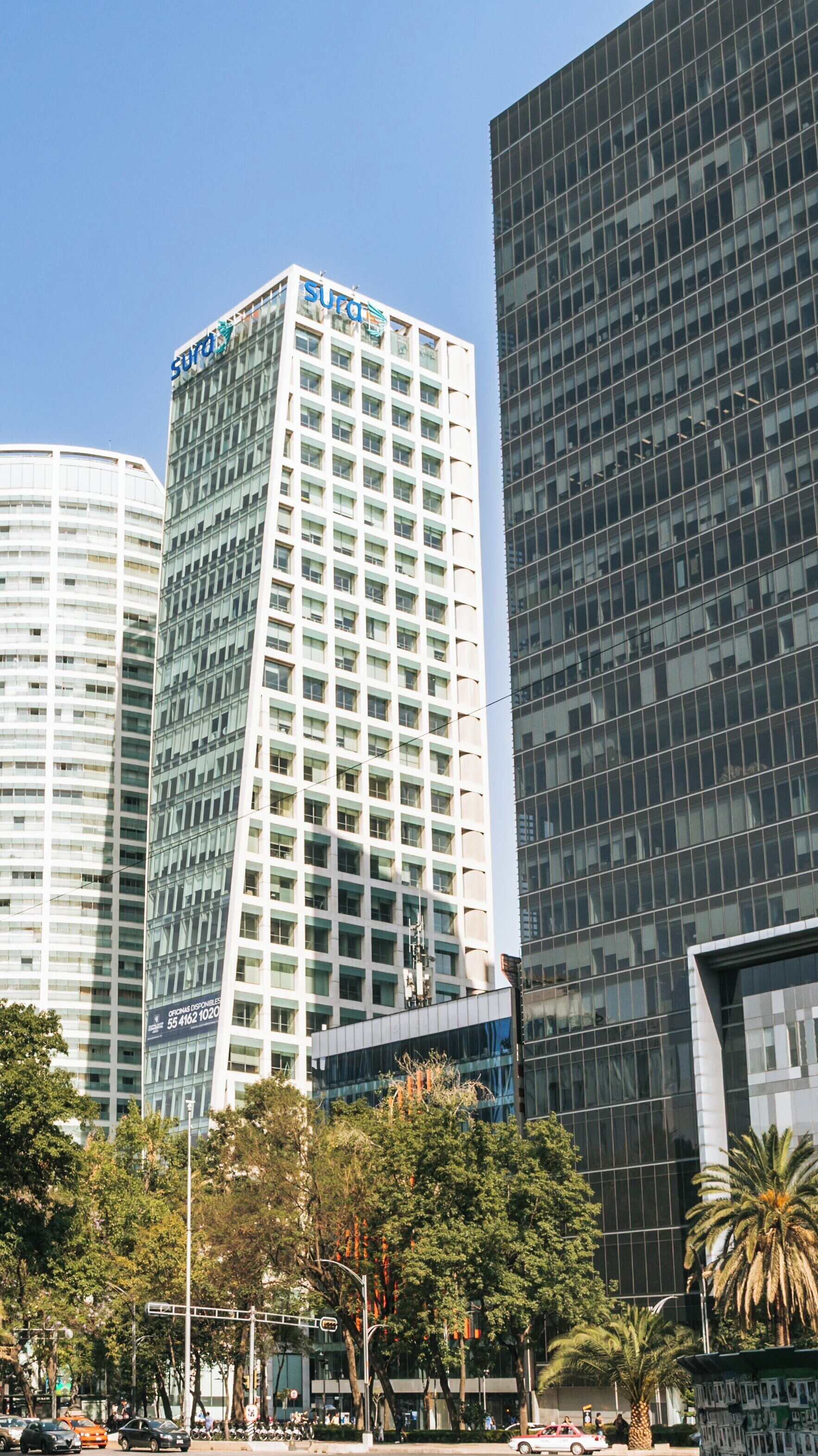 Paseo de la Reforma showcases modern architecture surrounded by lush greenery in Miguel Hidalgo, Mexico City under clear blue skies