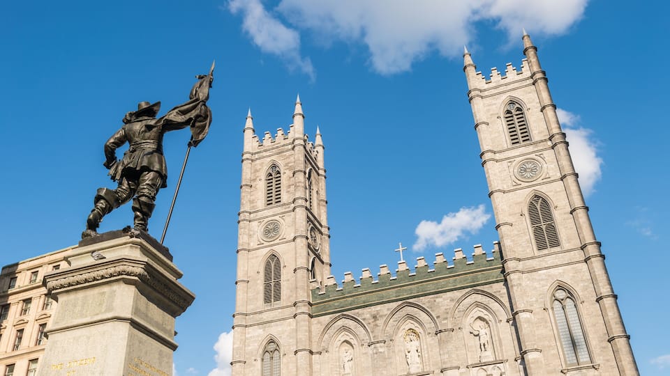 Montreal, Canada - 9 June 2017: Notre-Dame Basilica and Maisonneuve Monument