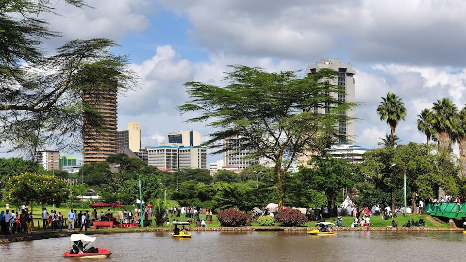 Nairobi's vibrant urban landscape alongside a serene park setting filled with people enjoying recreational activities