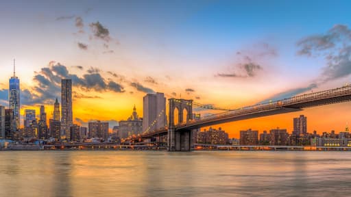 Brooklyn bridge and downtown New York City in beautiful sunset