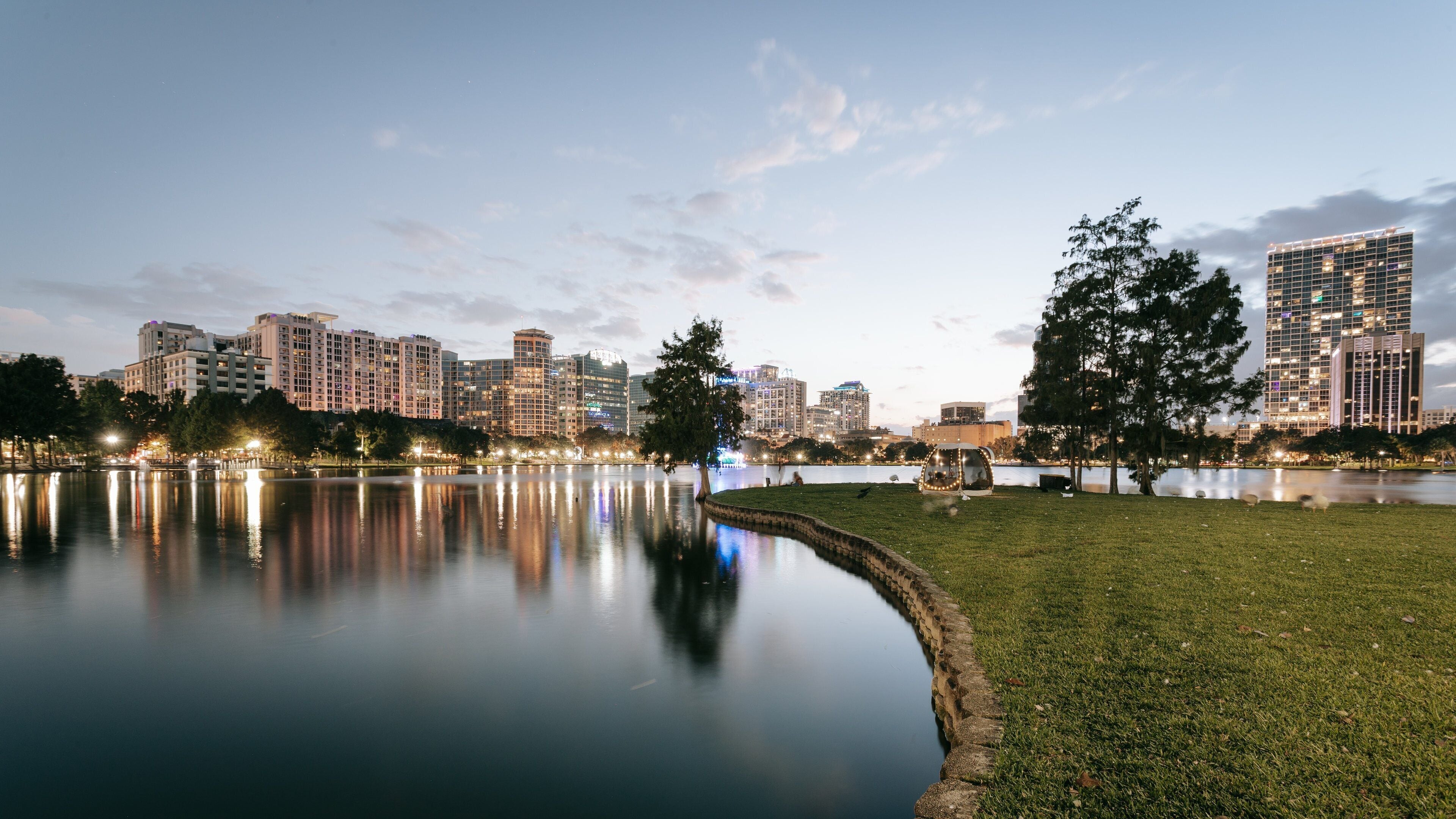 Orlando which includes a sunset, a pond and a city