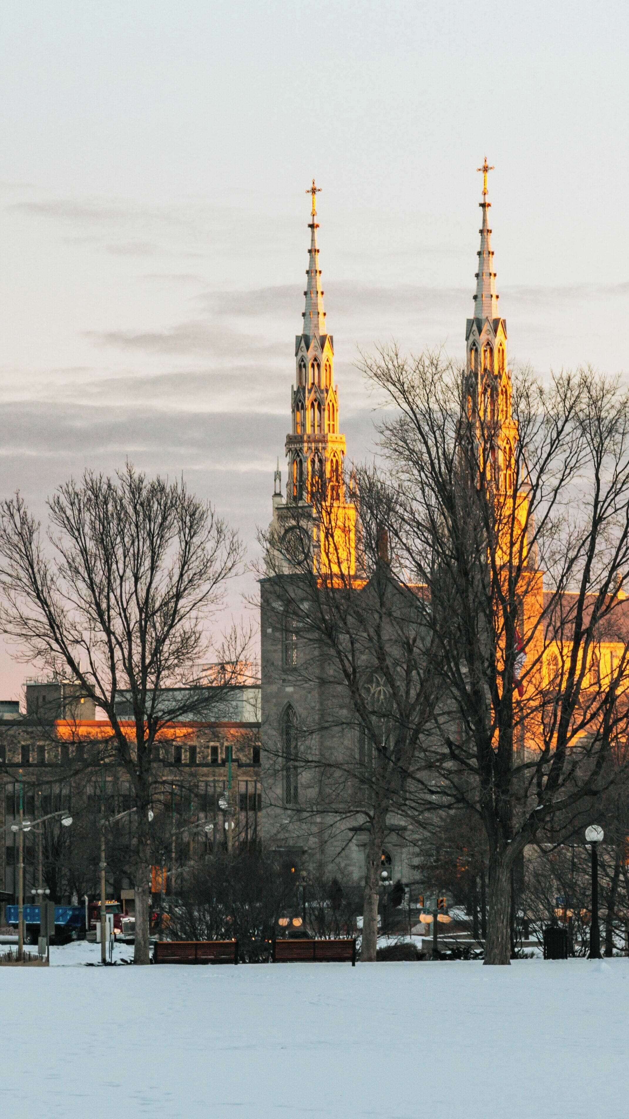 Majestic evening glow on Major's Hill Park with the impressive towers of Downtown Ottawa highlighted by sunset, Ontario, Canada