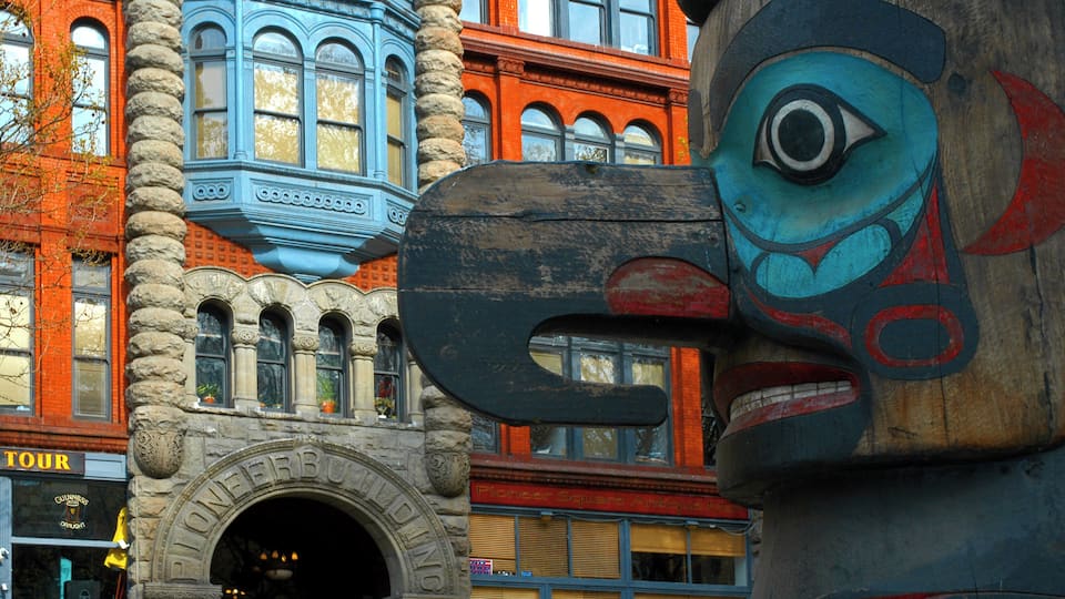 A building with a large wooden sculpture of a face.