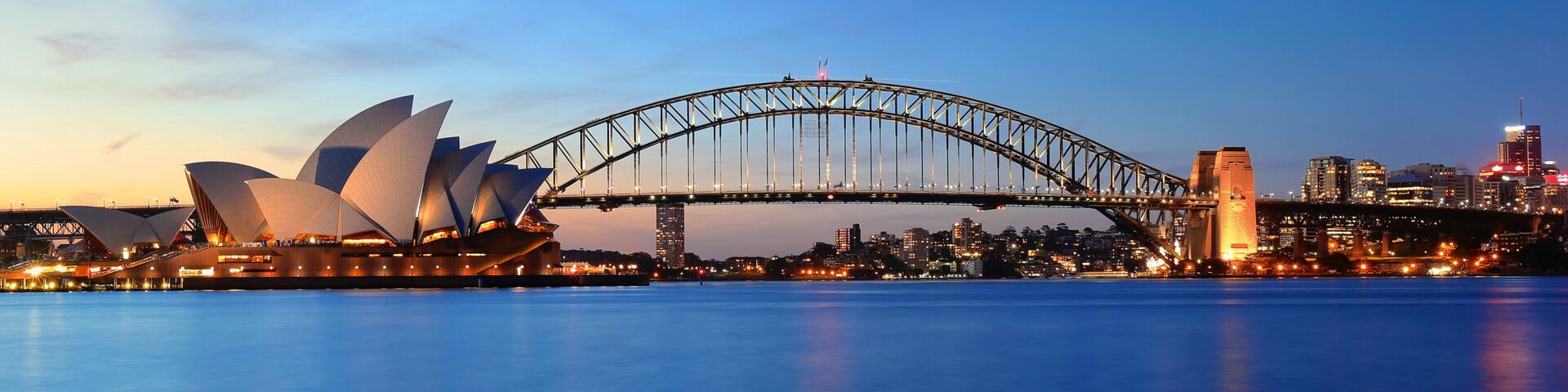The Sydney Opera House and Sydney Harbour Bridge at dusk.