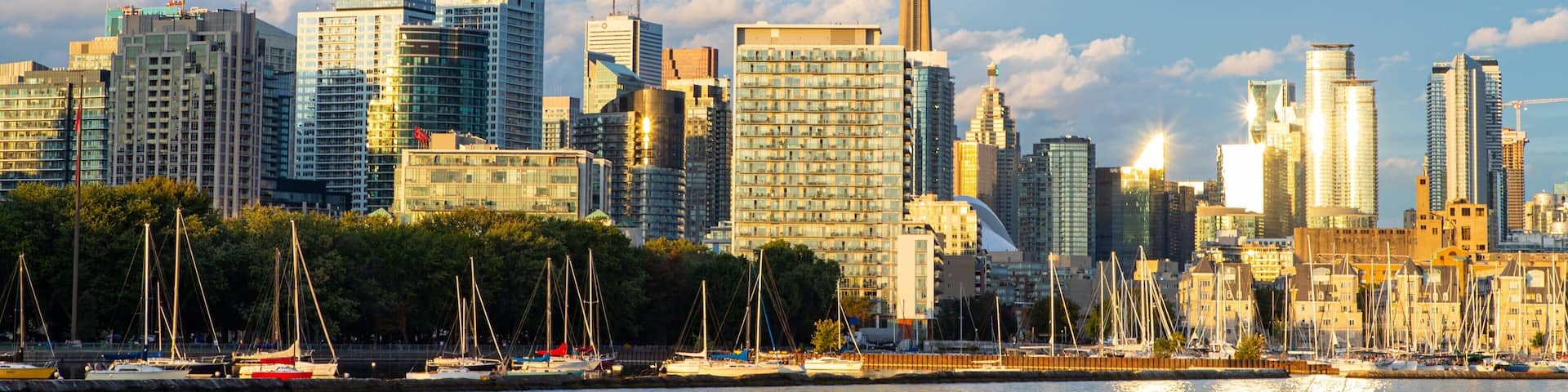 Toronto which includes a bay or harbor, a sunset and a city