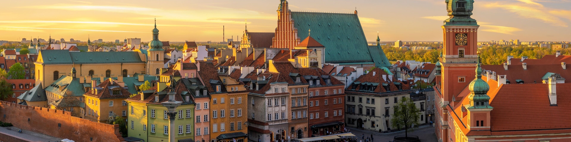 A historic European city square with colorful buildings, a prominent clock tower, and a large open plaza.