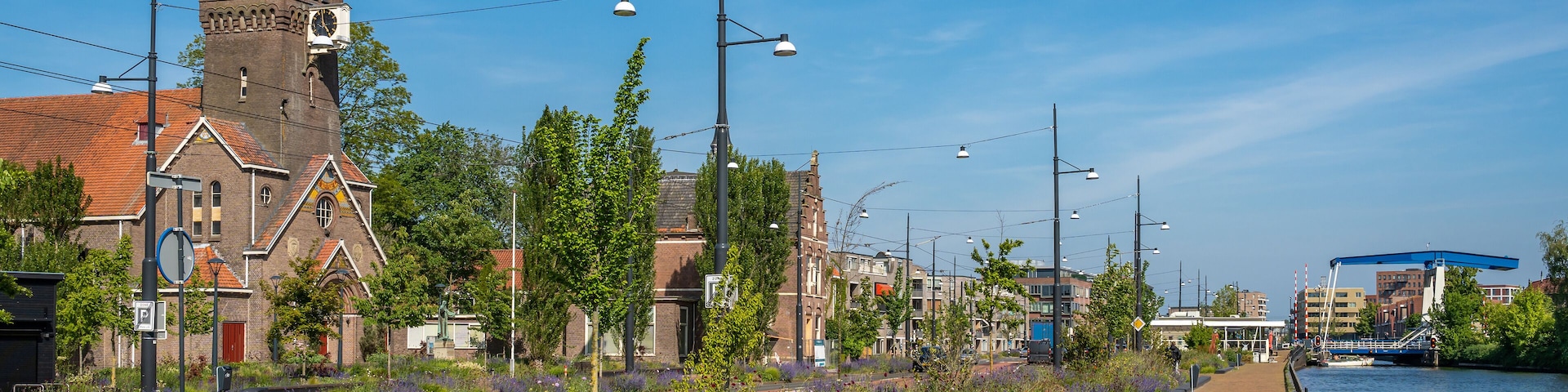 Townscape of Diemen, southeast of Amsterdam, view of Weespertrekvaart canal and Sint Petrus Banden church